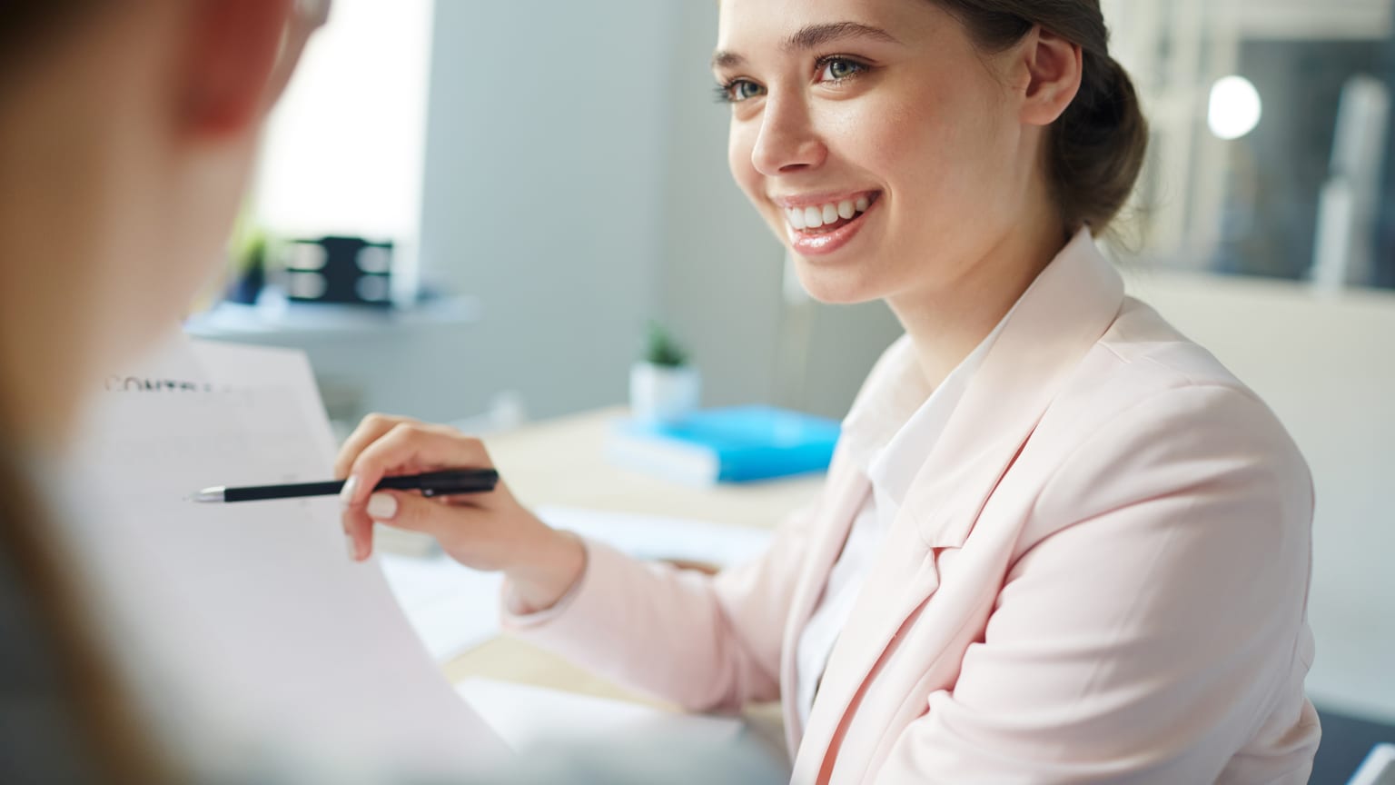 Accountants going through payroll documents — calculating net salary from gross pay