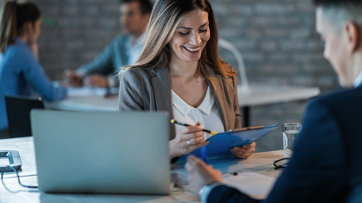 Colleagues going through documents in an office — a conversation about a pay rise